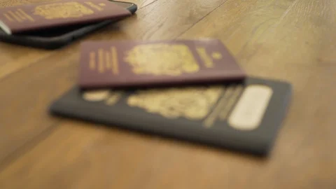 Rack Focus on old British and current EU passports Stock Footage 111777379