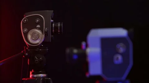 Rack focus from one camera to another on a black background Stock Footage 176393854