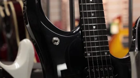 Rack focus from one guitar to another static Stock Footage 56036277