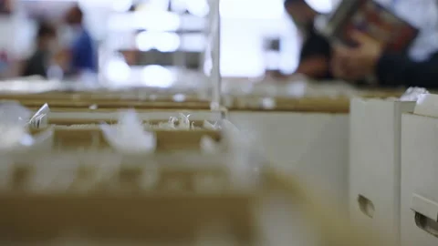 Rack focus people reading comic books store boxes slow motion 4K Stock Footage 171973705