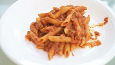 Rack focus plate closeup marinara sauce on meat bolognaise with penne pasta Stock Footage 165286387