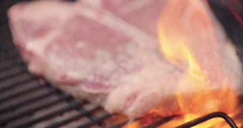 Rack focus raw steak on charcoal grill Stock Footage 140998152