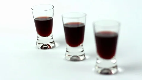 Rack Focus Red Alcohol Liqueur Shot-Glasses On White Background Video stock 72096090
