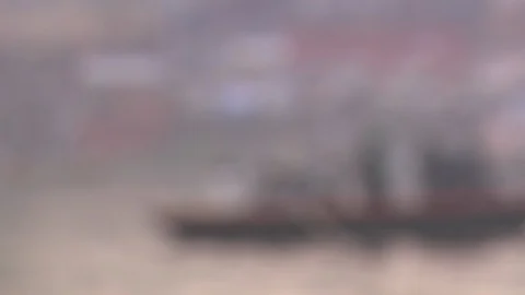 Rack focus to riverboats crossing on the Ganges River in Varanasi, India Stock Footage 86760465