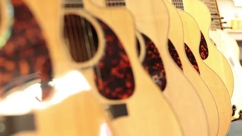 Rack focus row of acoustic guitars Stock Footage 69111251