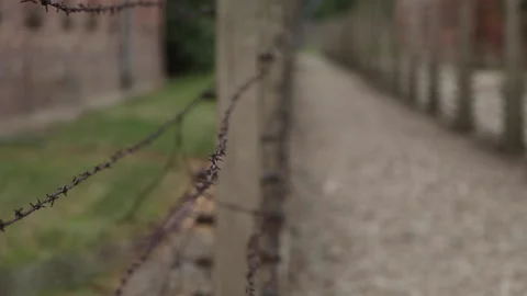 Rack Focus Shallow Depth Shot of Barb Wire Fence at Auschwitz Poland Vídeo Stock 143766344