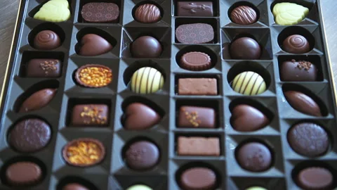 Rack focus shift of box of chocolates milk and dark truffles Stock Footage 165300270