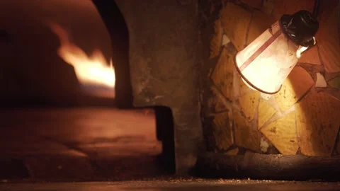 Rack Focus Shot of a Bakery oven with Fire Burning Inside Lamp in front Stock Footage 208662144