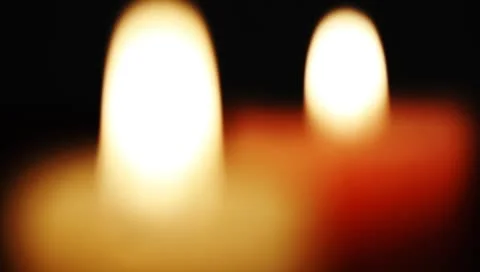 Rack focus shot of Candle burning and flickering Stock Footage 8956502