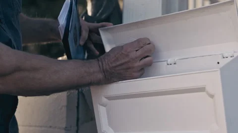 Rack focus shot of a man removing vacant sticker from inside mailbox, USA - Reen Stock Footage 238871414