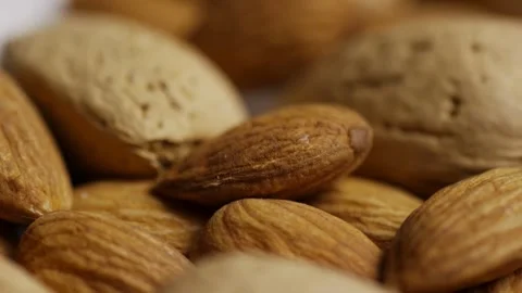 Rack focus shot of pile of mixed raw almonds Stock Footage 327911812