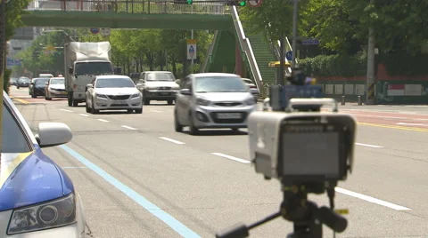 Rack focus shot of speed camera by police car on road Stock Footage 41870572
