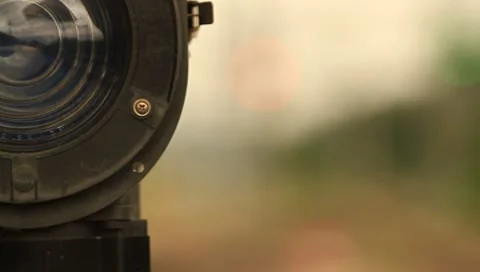 Rack focus shot from a train sign light to a train passing by at the station Stock Footage 8640028