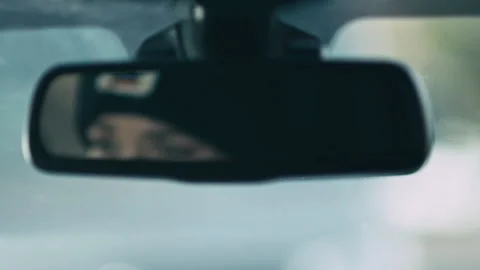 Rack focus shot of a woman's reflection in rear view mirror, USA - Reenactment Stock Footage 238871342