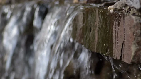 Rack focus side close up water fall from stream leaves flowing 스톡 동영상 91296131