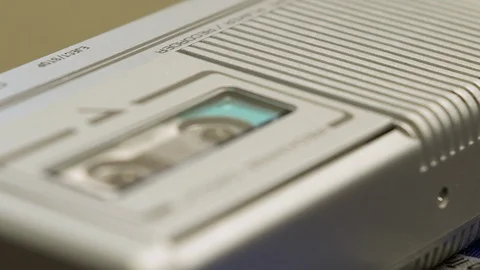 Rack Focus From Speaker To Tape Spools Turning In Microcassette Recorder Stock Footage 128438237
