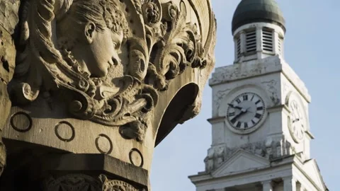 Rack Focus of Stone Carving to Clock Tower in Small Town Stock-Footage 231239989