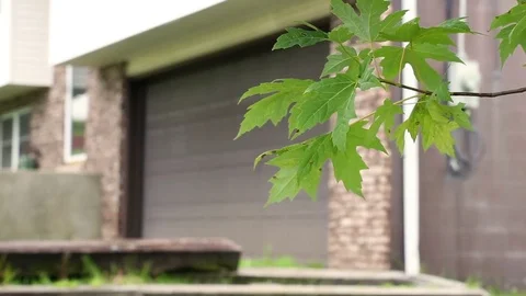 Rack focus to a suburban garage in split entry home during daytime Video stock 78045222