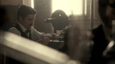 Rack focus of Thomas Edison and Nikola Tesla working together in laboratory, USA Stock Footage 236632164