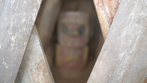 Rack focus through fence to a colored ancient statue at El Pelota in Colombia Stock-Footage 109076471