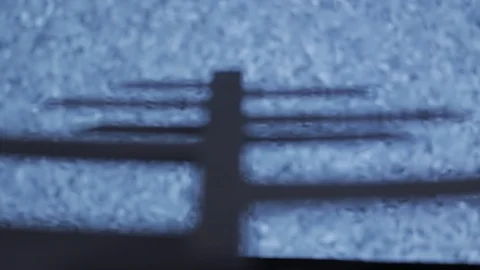 Rack Focus of TV Antenna in front of No Signal/Off Air TV Station. Stock Footage 88337513