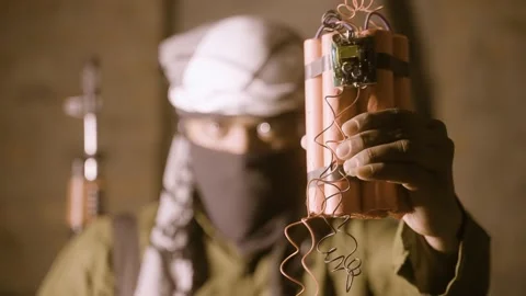 Rack focusing shot of Terrorist showing bomb Stock Footage 159700342
