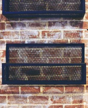 Rack grid on a brick wall background Stock Photos