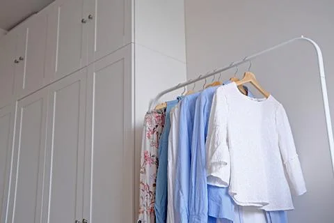 Rack with hanging clothes in the interior of the dressing room. Stock Photos