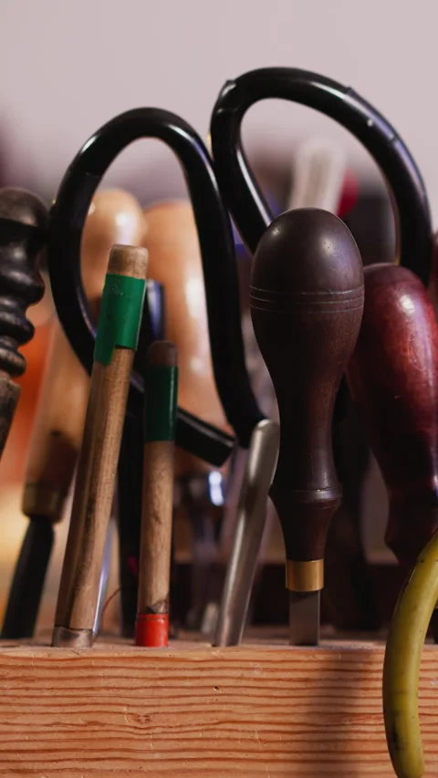 Rack with kit of different leathersmith tools on workbench Stock Footage 307774282