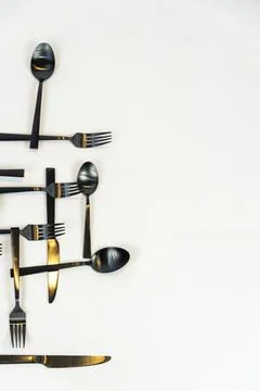 Rack of kitchen utensils, isolated on white. Stainless steel with black handles Stock Photos