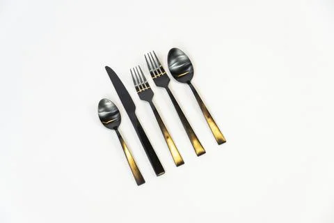 Rack of kitchen utensils, isolated on white. Stainless steel with black handles Stock Photos