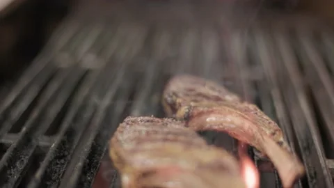 Rack of lamb being grilled in restaurant kitchen, cook, chef, grilling meat. 4K Stock Footage 236192914