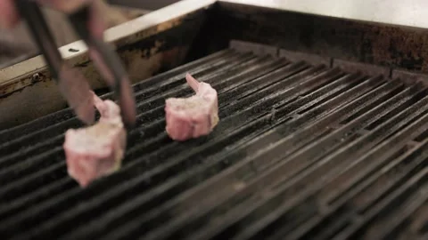 Rack of lamb being grilled in restaurant kitchen, cook, chef, grilling meat. 4K Stock Footage 237340665