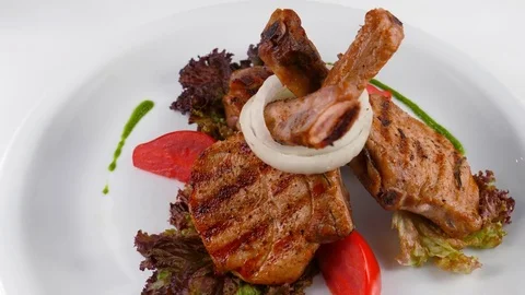 Rack of lamb, grilled meat with bone, served in Restaurant Stock Footage 79712829