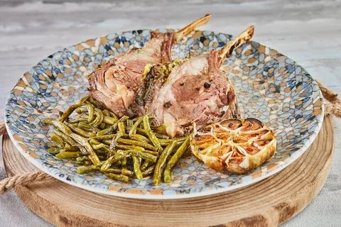 Rack of lamb medium rare, baked with green beans and garlic Stock Photos