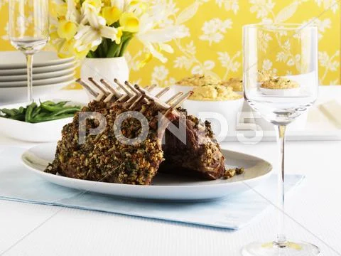 Rack of lamb with nut and herb crust, potato soufflé Stock Photos