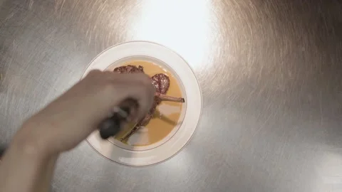 Rack of lamb on a white plate in restaurant kitchen, cook, chef, grilling meat Stock Footage 236192933