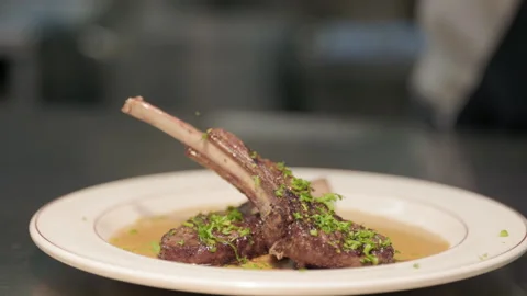 Rack of lamb on a white plate in restaurant kitchen, cook, chef, grilling meat Stock Footage 236193017