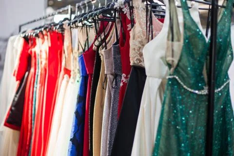 Rack with a multi-colored evening dresses. Stock Photos