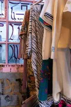 Rack of second-hand autumn, winter clothes with prints and patterns in front of Stock Photos