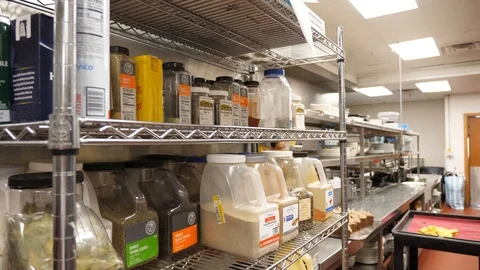 Rack of spices oils and various ingredients in restaurant kitchen camera jibs Video stock 89383727