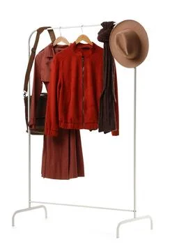 Rack with stylish jackets and accessories on white background Foto stock