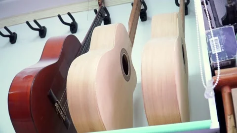 Rack view of guitars professionally assembled in a luthier woodworker Stock Footage 220760189