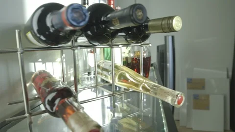 Rack Of Wine Bottles On Glass Table Stock Footage 121288017
