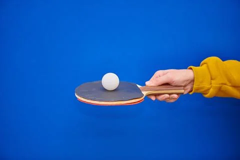 Racket with a ball on a blue background Stock Photos