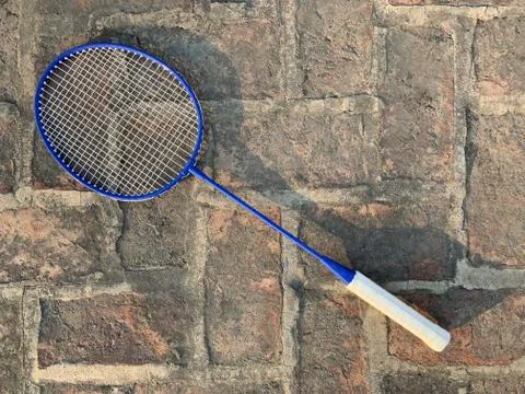 Racket for playing badminton on a rough background. Stock Photos