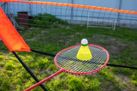 A racket with a shuttlecock and a net to practice badminton. Summer active ga Stock Photos