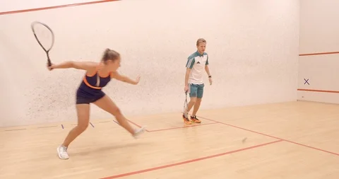 A Racketball coach and client having fun and playing a rally. Vídeo Stock 85533827