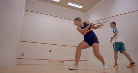 A Racketball coach teaching his client some moves. Stock Footage