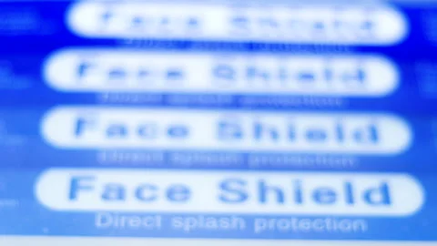 Rackfocus stack of blue face shield to protect from tiny droplets carrying flu Video stock 145039929